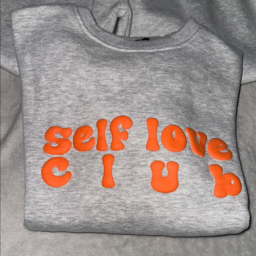 Pretty Little Thing Sweatshirt with Orange “self love club” bubble Print